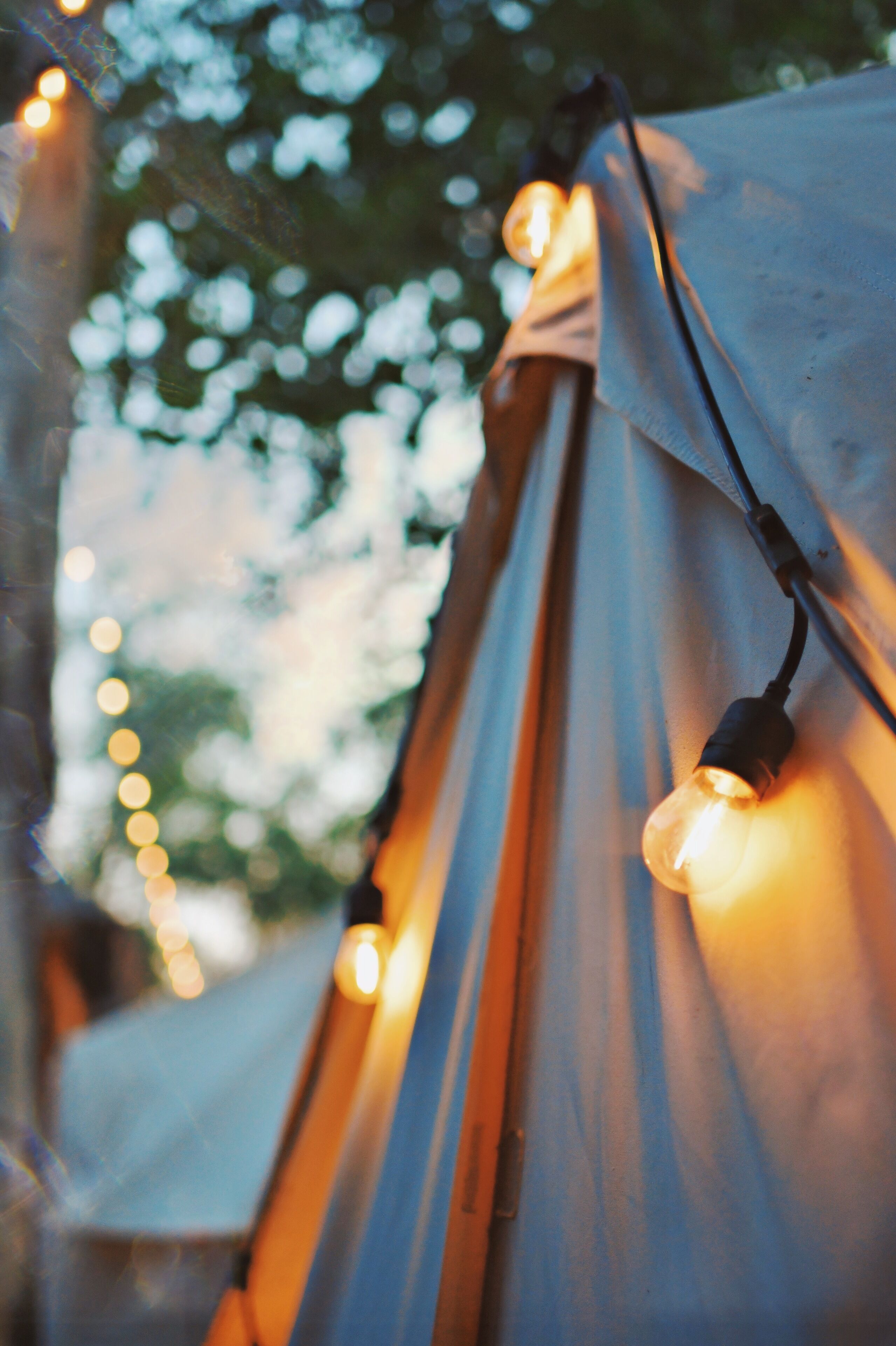 A close-up of a tent with string lights.