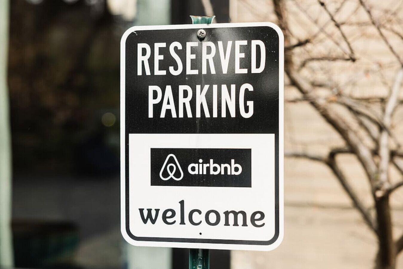 A sign indicating reserved parking for Airbnb guests.