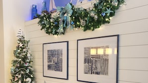 A decorated interior with a Christmas tree, framed artwork, and a cabinet with a 'Dream' sign. - LUXURY WINDSOR HILLS 4 BR 5BA POOL & SPA HOME 2.5 MILES to DSNY +++ (Kissimmee)
