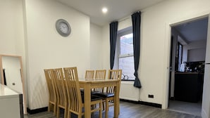 A modern kitchen with a dining area.