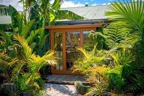 Escape to a serene oasis surrounded by lush tropical vegetation and vibrant plants.