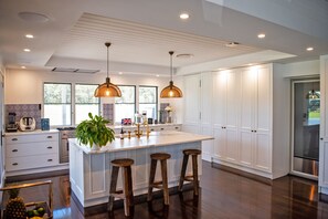 Enjoy cooking in this well-lit kitchen with ample workspace and seating for three.