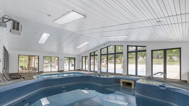 A large indoor swimming pool with clear views of the outside. - 2 bedroom, 2 bath ground floor condo with indoor pool minutes from Branson strip (Branson)