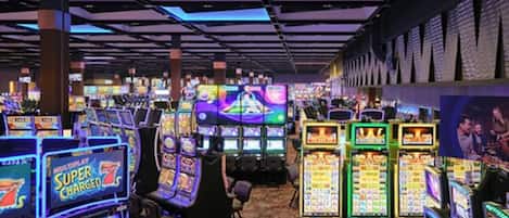 A casino with multiple slot machines and gaming tables.