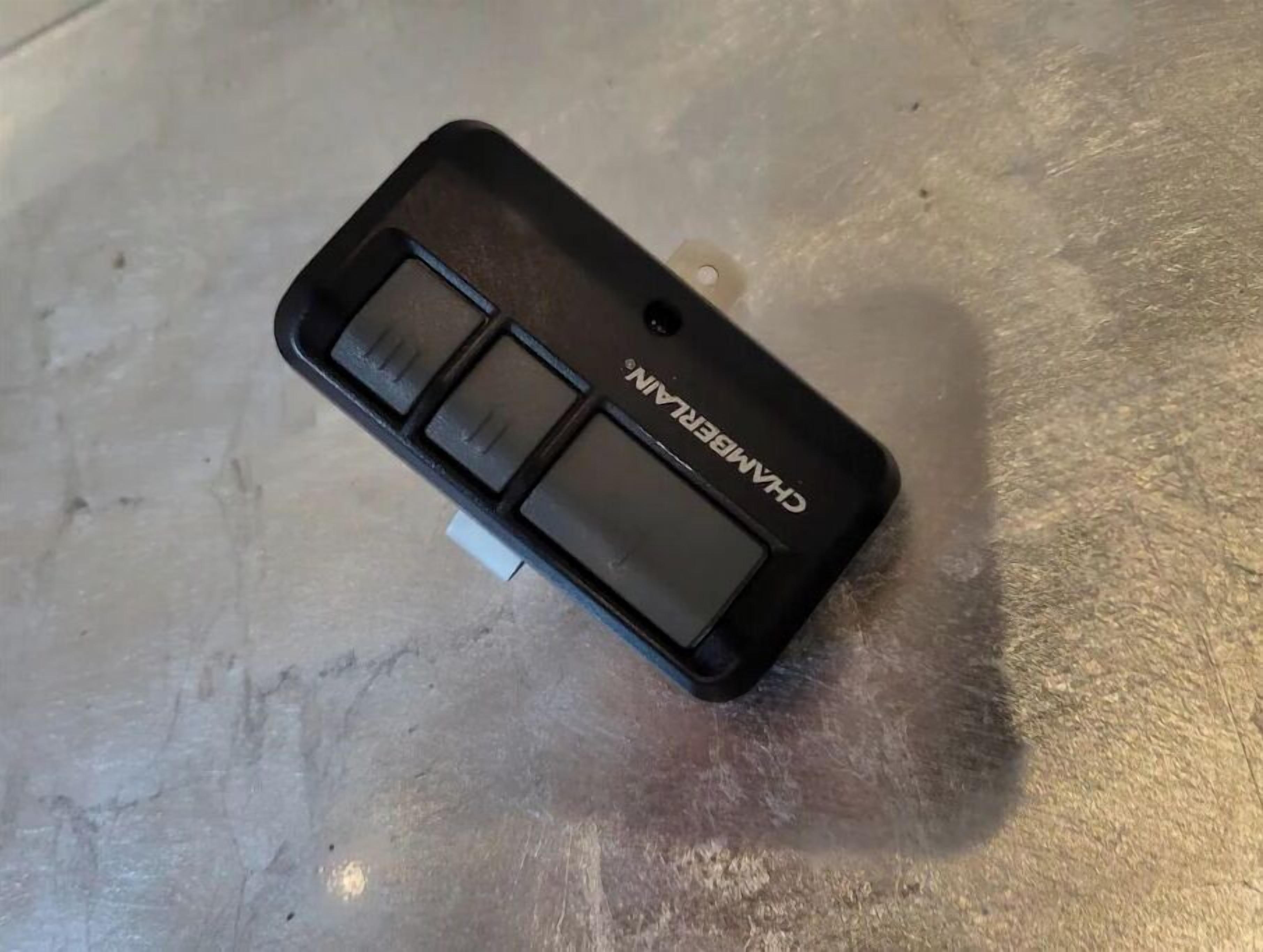 A black object with the text "CHAMBERLAIN" on it, placed on a metallic surface.