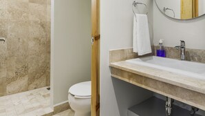 A modern bathroom with a marble shower, a toilet, a sink with a mirror, and a towel rack. - Lago Zirahuén By HomiRent (Mexico City)