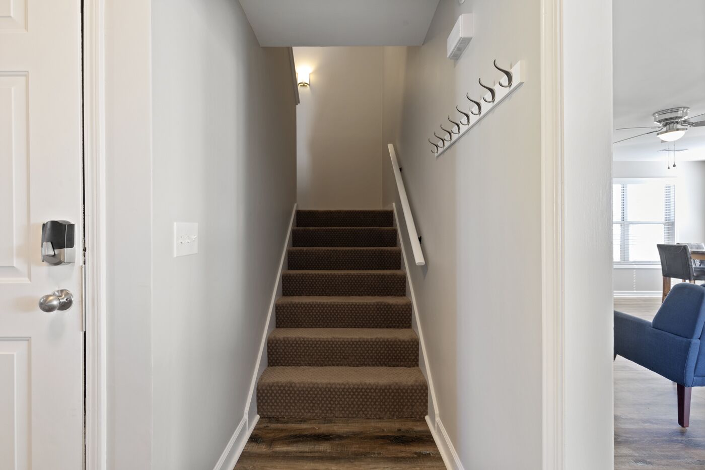 A staircase with carpeted steps leading to a landing.