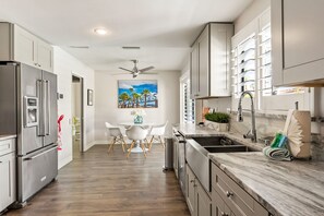 Enjoy cooking in this well-equipped kitchen with stainless steel appliances, ample counter space, and a central island with seating.