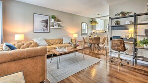 A modern living room with a sofa, coffee table, and a dining area with chairs and a table. - 1 Mi to Dtwn Burbank: Mod Gem w/ Private Yard (Burbank)