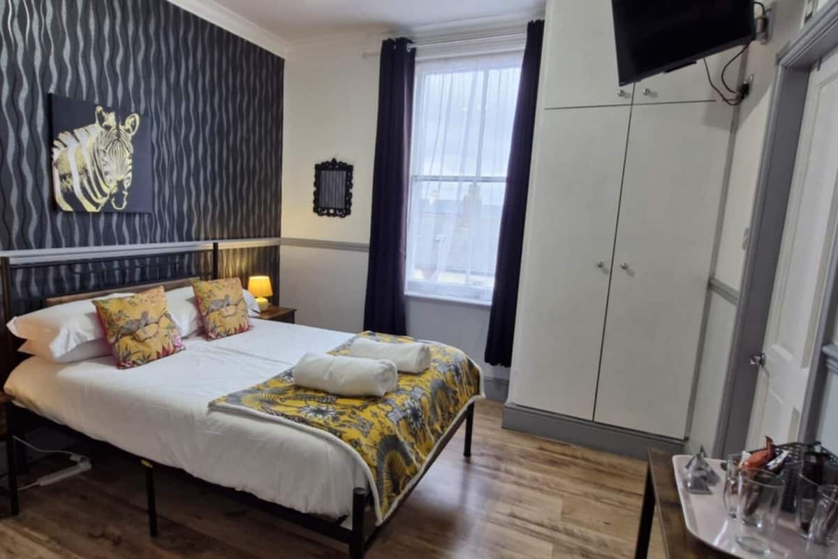 Premium bedding, pillowtop beds, laptop workspace, blackout drapes