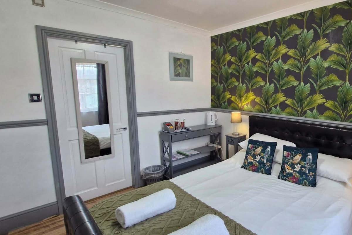 Premium bedding, pillowtop beds, laptop workspace, blackout drapes