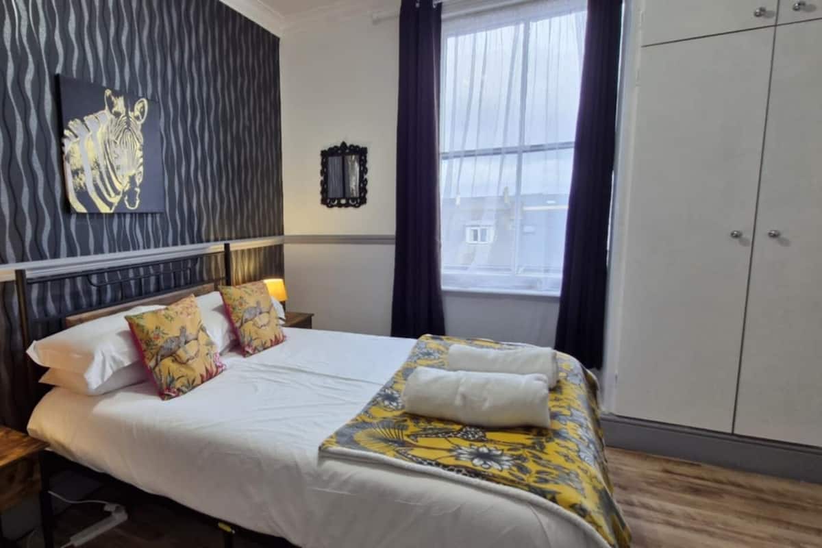 Premium bedding, pillowtop beds, laptop workspace, blackout drapes