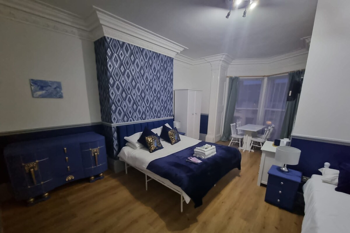Premium bedding, pillow-top beds, laptop workspace, blackout curtains
