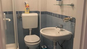 A bathroom with a toilet, sink, and shower. - Apartments Semafor - One Bedroom Apartment with Terrace and Sea View A3 (Seget Vranjica)