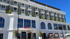 A multi-story building with a casino sign, large windows, and a red carpet entrance. - Trestraou - Perros Guirec (PERROS GUIREC)