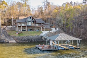 A lakeside lodge with a dock and outdoor seating area. -  "LAKEVIEW": No Steps, HOT TUB, Boat/Swim Dock, Elevator (Arley)