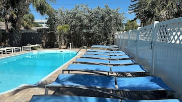 A heated pool, sun loungers