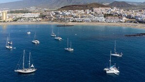 A coastal town with a marina filled with sailboats. - Home2Book Beachfront Design&Views Los Cristianos (Los Cristianos)