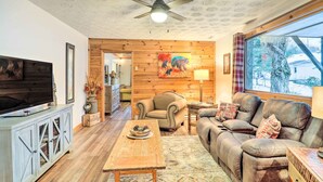 A cozy living room with a television, leather sofa, and a wooden coffee table. - Mountain Retreat < 4 Mi to Downtown Boone! (Boone)