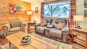 A cozy living room with a brown leather sofa, a striped armchair, and a wooden coffee table. - Mountain Retreat < 4 Mi to Downtown Boone! (Boone)