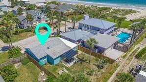 An aerial view of a coastal residential area with houses, a swimming pool, and a beach in the background. - Blue Ocean ~ Pet Friendly ~ One house off the Beach! (Saint Augustine)