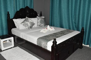 Relax in a cozy retreat with a four-poster bed and elegant runner.