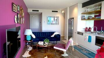 Design Apartment | Living area | 55-inch LED TV with cable channels, TV