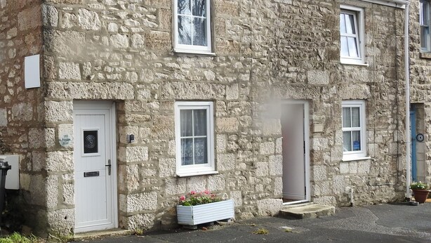 A stone building with three windows and a door. - Pebble Reef (Portland)