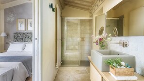 A modern bathroom with a shower, a large sink, and a mirror.