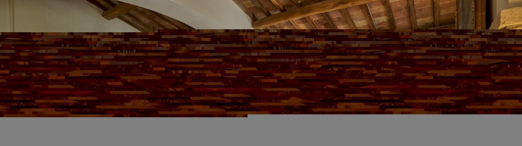 A room with a high ceiling and exposed wooden beams.