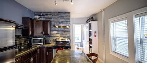 Enjoy cooking in this well-equipped kitchen with a refrigerator, microwave, and large island.