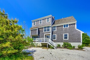Stroll up to the charming two-story home with a welcoming front porch and beautifully landscaped surroundings.