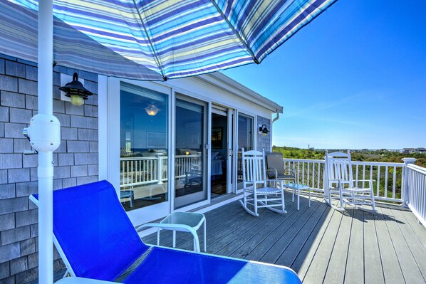 Relax on the deck with a lounge chair and rocking chairs, taking in the surrounding views.