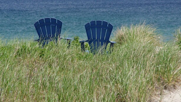 Two blue Adirondack chairs facing the ocean. - Oceanfront Cottage—Private Beach & Bay Views (East Sandwich)