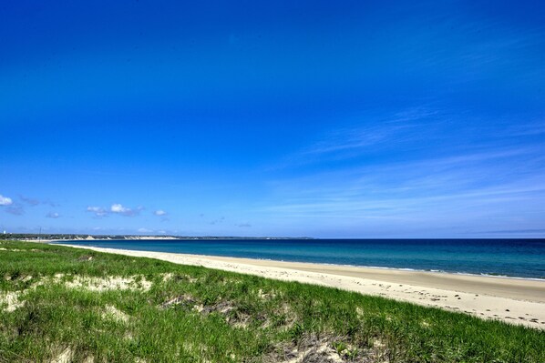 A beach with a clear sky and a sandy shore.