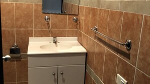 A bathroom with a white sink, a mirror above it, and a towel rack on the wall. - BEAUTIFUL APARTMENT WITH GREEN TERRACE (Cholula)