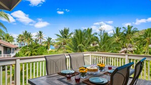 An outdoor dining area with a wooden table set for four, surrounded by chairs. - STEPS FROM STUNNING MOLOAA BAY (Anahola)