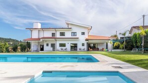 A modern two-story house with a swimming pool in the foreground. - 6-bed House - Sleeps 12 - Pool, Bbq, Pool Table (Guimarães)