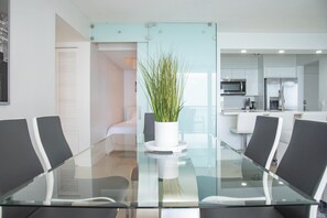 Enjoy meals in this stylish dining area with a glass-top table and comfortable seating.