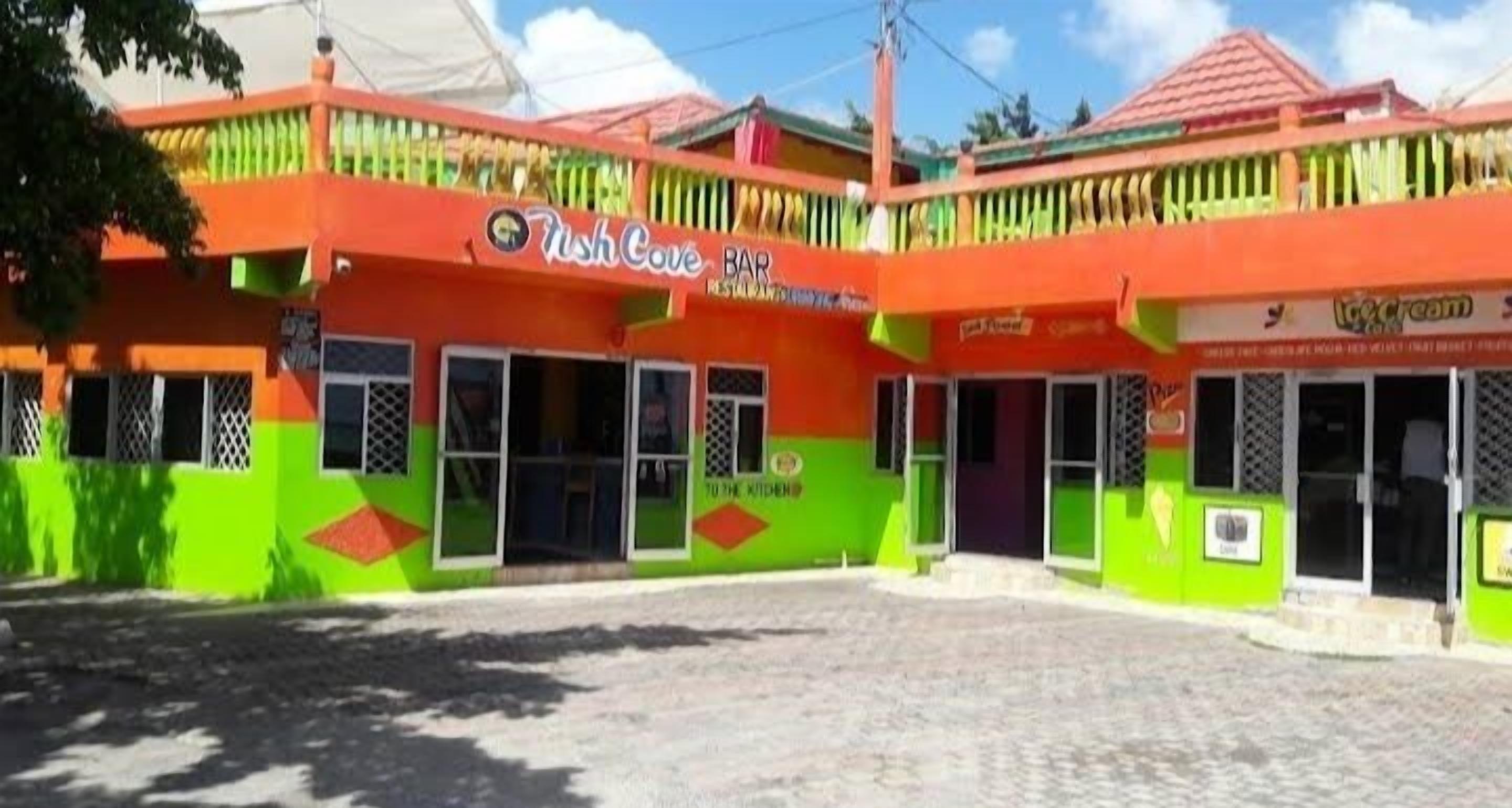 A colorful building with a sign for 'Rush Cove Bar' and 'Ice Cream'.