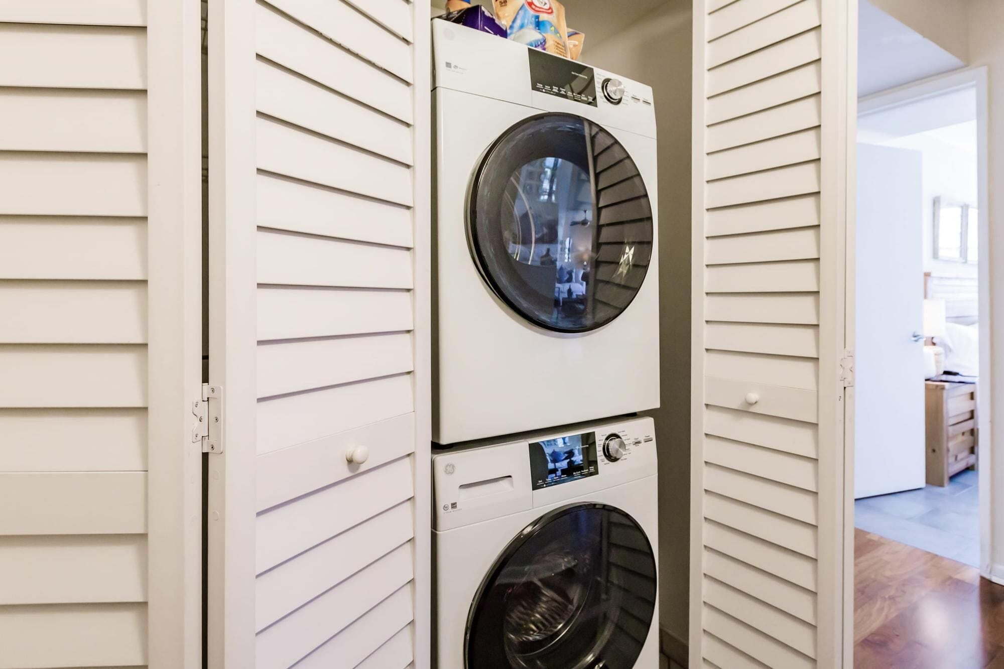 A laundry room with two stacked front-loading washing machines.