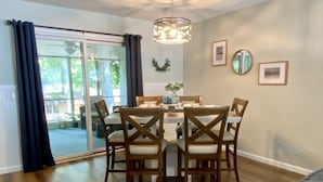 A dining area with a round table and six wooden chairs with cushioned seats. - Welcoming, Roomy and Conveniently Located! (Hot Springs Village)
