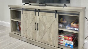A wooden entertainment center with a flat-screen TV mounted above it. - Modern Home In Melbourne (Melbourne)