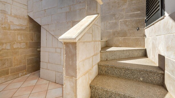 A set of stone steps with a handrail, leading to a door with a black metal shutter. - 2516 Villa Marea - Appartamento Bassamarea by Barbarhouse (Salve)