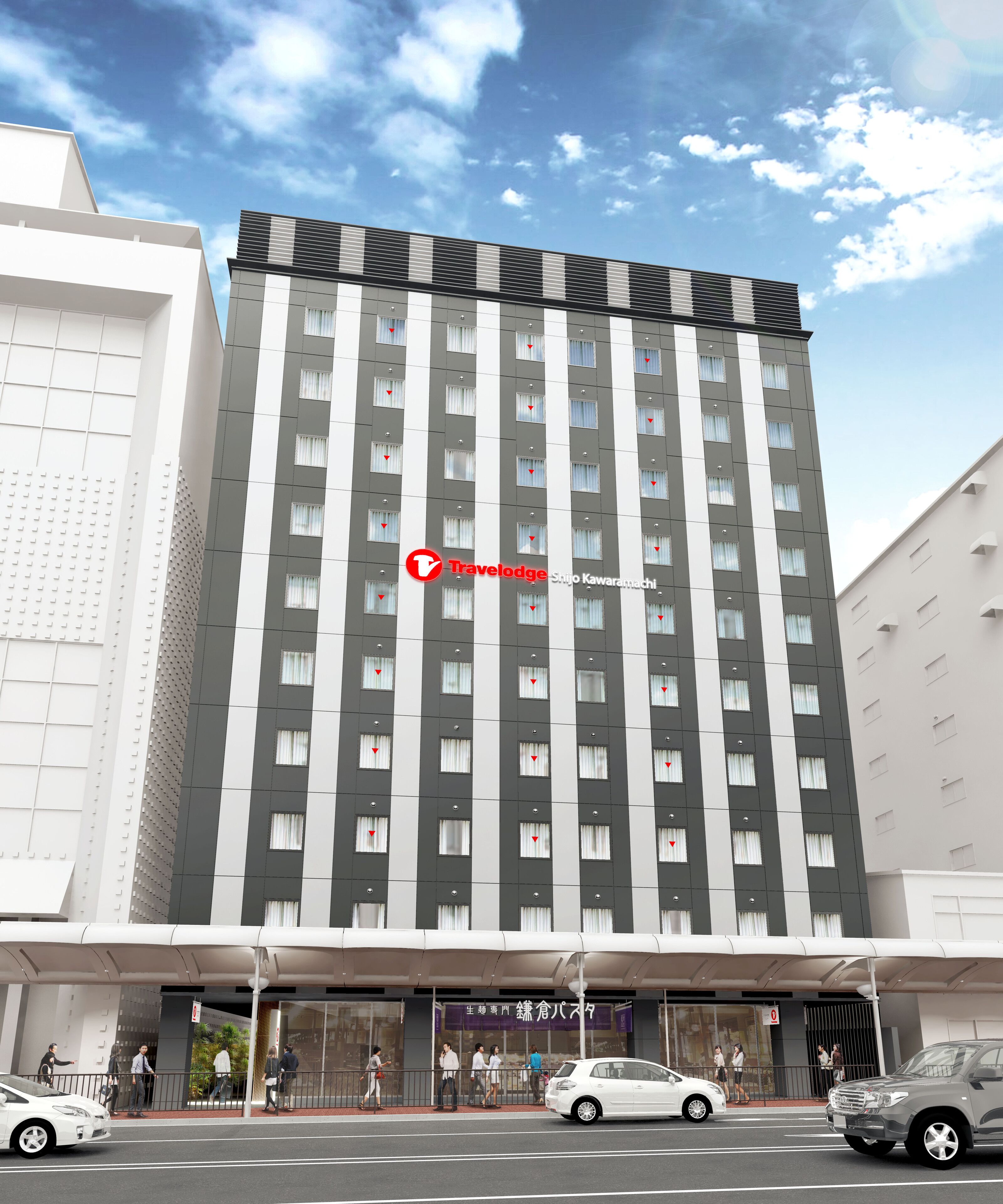 A tall hotel with a modern design, featuring a prominent entrance and a covered walkway.