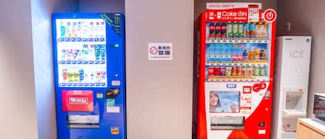 A vending machine area with a Wonda and a Coca-Cola machine, and an ICE refrigerator.