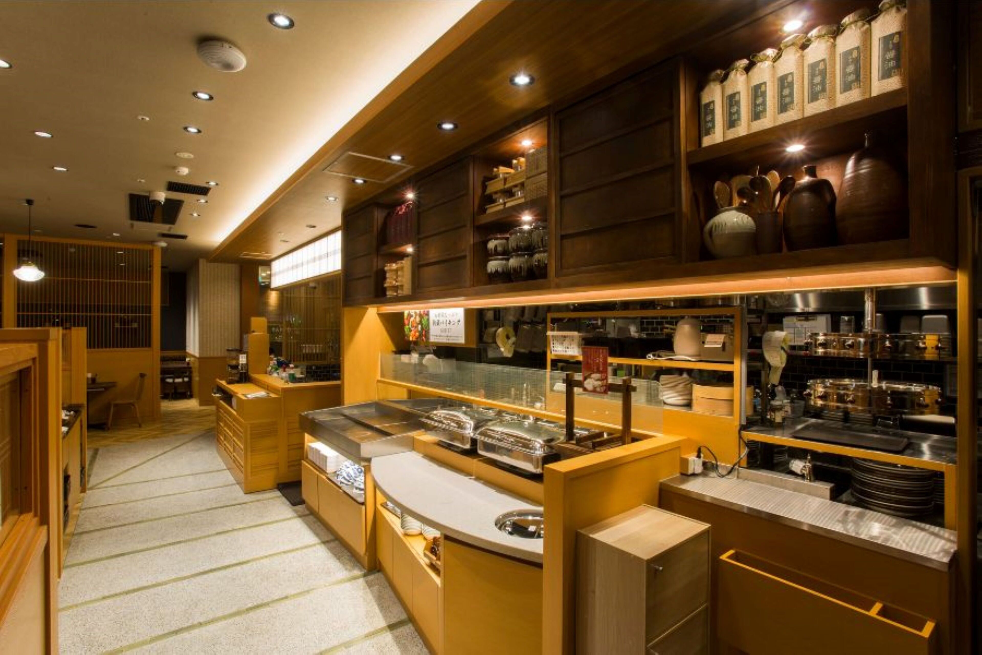 A restaurant with a buffet setup, wooden decor, and various kitchen equipment.
