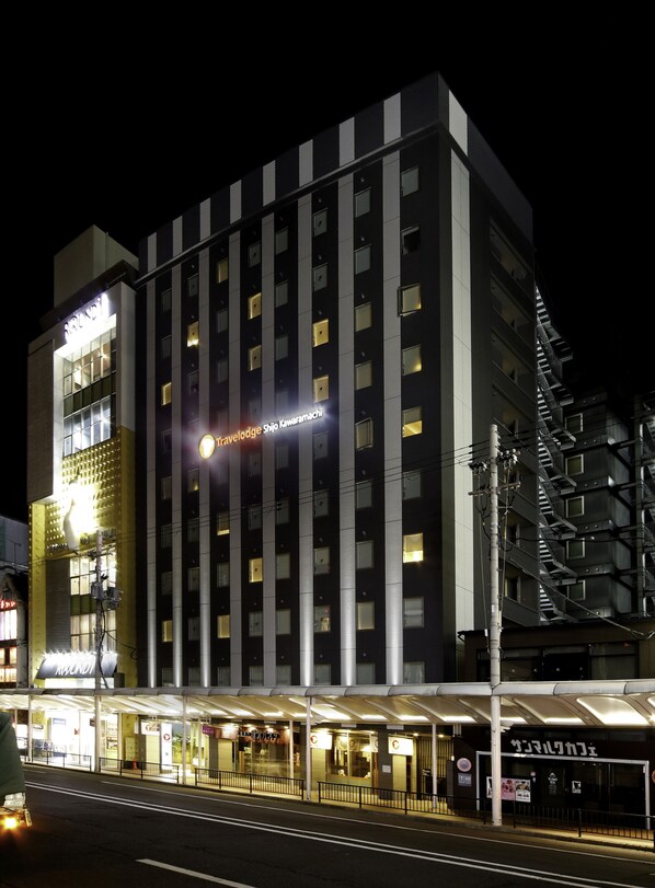 Experience the sleek, modern design of Travelodge Shijo Kawaramachi, featuring a covered entrance and spacious balconies.