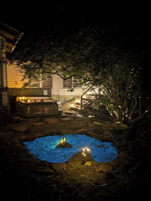 A backyard with a hot tub, a small pond, and a house in the background. - 1875 Historic Manor, 5 Acres Near Helen & Wineries (Baldwin)