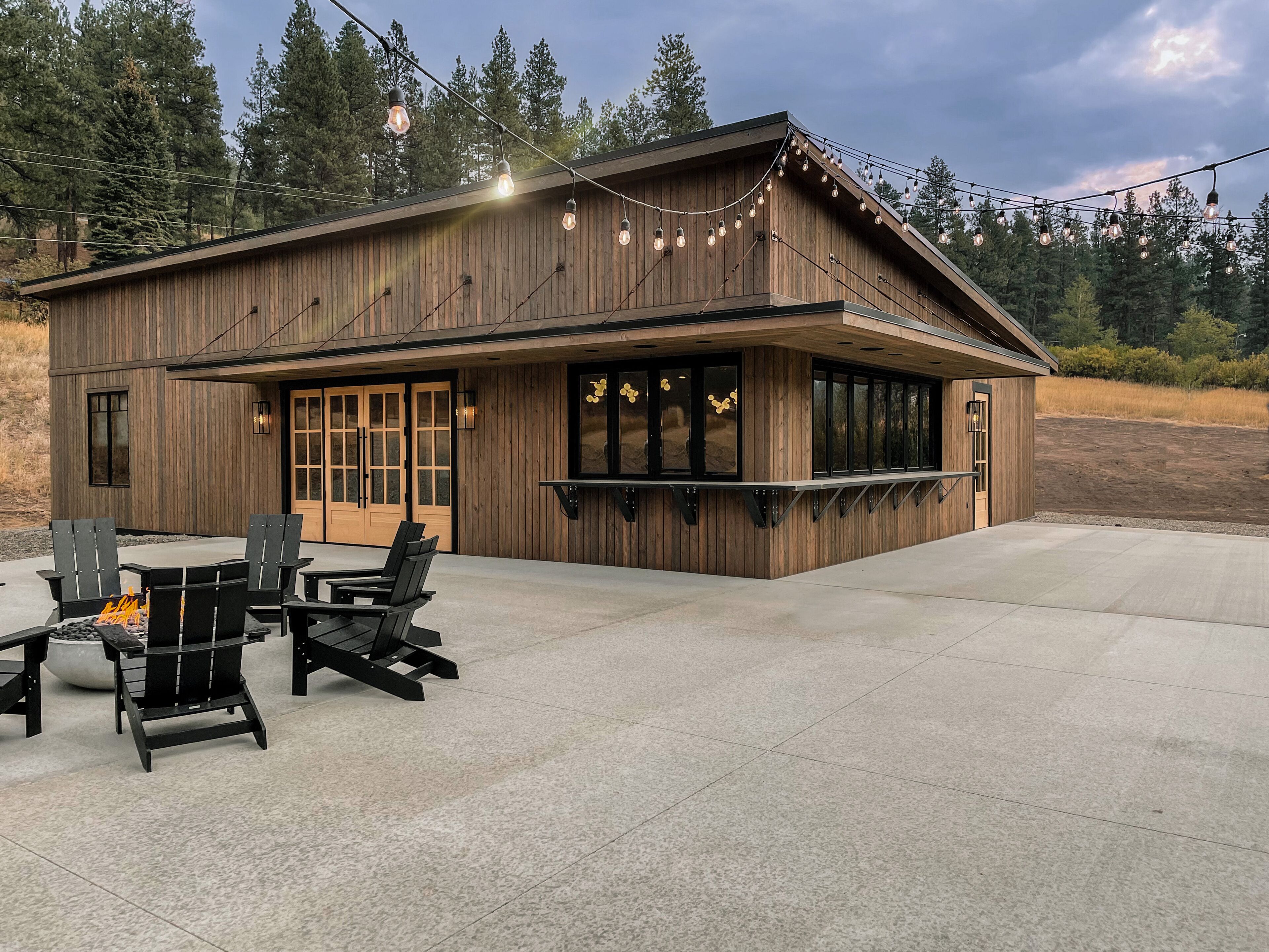 Modern cabin on 10 creek front acres with large gas fire pit.
